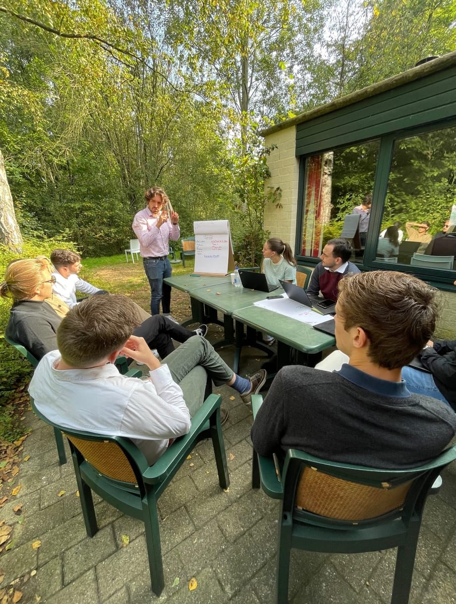 Jason Wood facilitating an outdoor workshop, in front of a flip chart and a group of participants