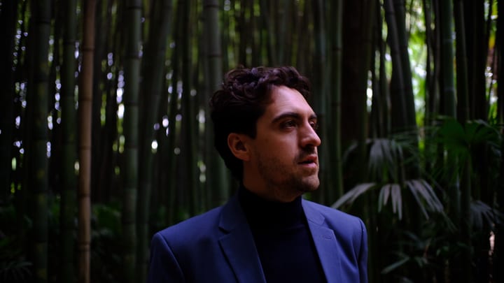 Jason Wood, fondateur Onivio, consultant CX/EX, photographié dans un jardin de bambous